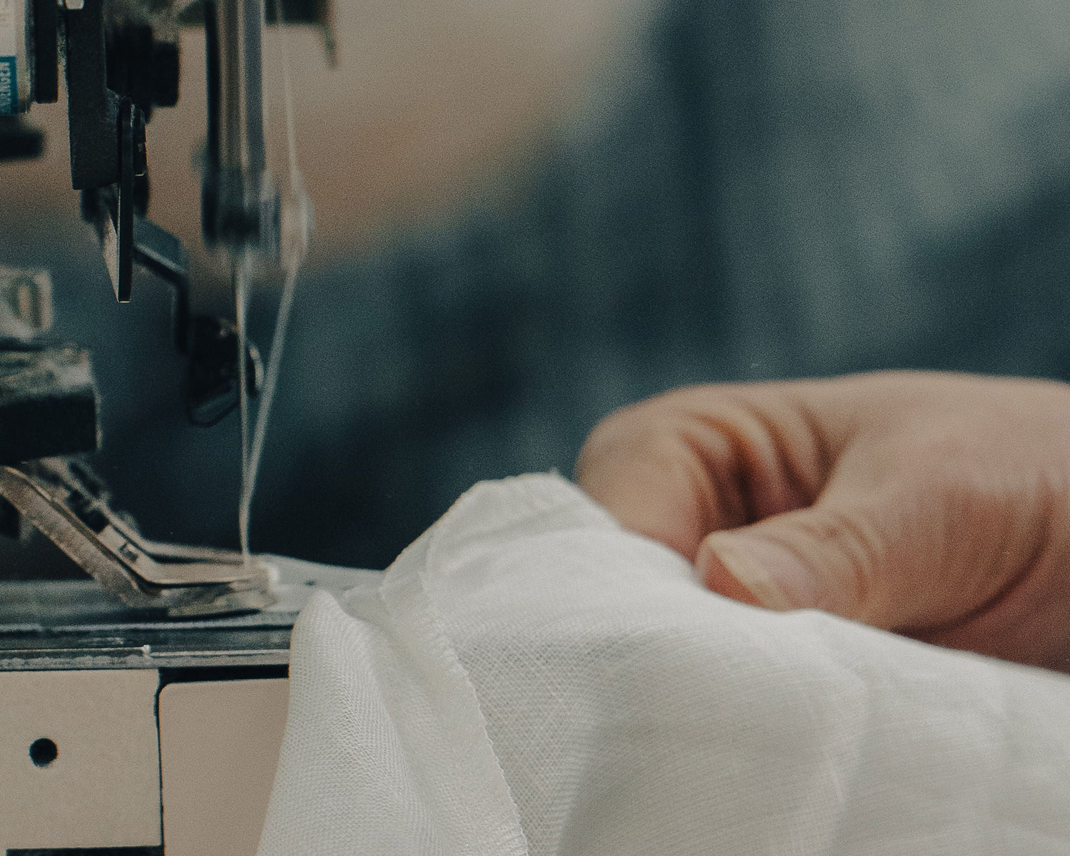Person sewing fabric with a sewing machine